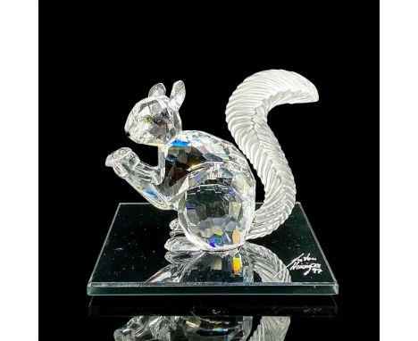 Clear faceted crystal figure of a squirrel holding a crystal. Includes artist signed black glass base, 3"W x 3"L. This item h