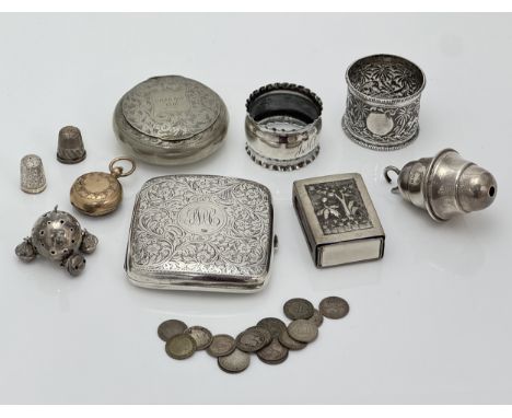 A range of silver and white metal items. To include a silver cigarette case, silver rattle (AF), some silver coins, two silve