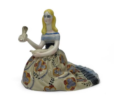 A Lenci pottery figure modelled as a kneeling girl dressed in a flowing florally patterned dress holding a dove in each hand,