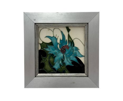 Moorcroft, a small Moorcroft tile in the Sea Holly pattern. Signed to reverse. 8.5cm x 8.5cm, frame measures 13.5cm x 13.5cm.