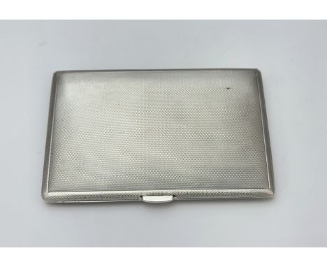 A silver cigarette case with engine turned pattern by S J Rose &amp; Son, Birmingham 1961. Width 12.5cm.