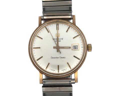 A Tissot Seastar Seven gents watch with date aperture, silver dial and gold baton markers, on a stainless steel bracelet.