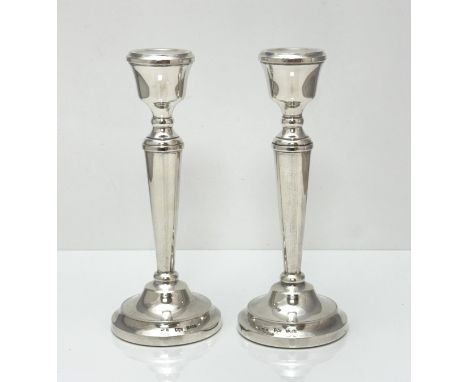 A pair of Mappin &amp; Webb filled silver candlesticks, Birmingham 1954. 21cm high.