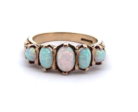 A five stone opal ring set in a 9ct gold scroll mount, size O. Opals in good condition with only light surface scratches. 4.1
