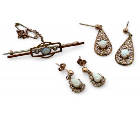 A collection of opal jewellery. An opal and seed pearl set bar brooch with steel pin, stamped 9ct. And two pairs of opal set 