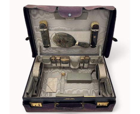 A Finnigan's of New Bond street ladies travelling / vanity case. Comprising of three glass scent bottles and three glass cont