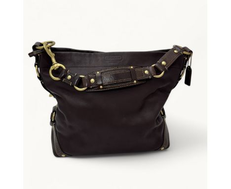 Coach  - a vintage crossbody handbag in mahogany brown leather, featuring a front slip pocket, adjustable leather crossbody s