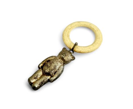 An early 20th Century teething ring with a silver-coloured teddy bear figure attached. Bear measures 5.5cm.