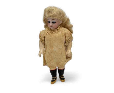 A small articulated bisque doll with blue glass eyes, unmarked, approx 5" high.