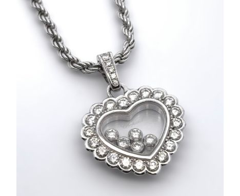 A Chopard 'Happy Diamond' 18ct white gold heart pendant. The heart frame set with round brilliant cut diamonds in white claw 