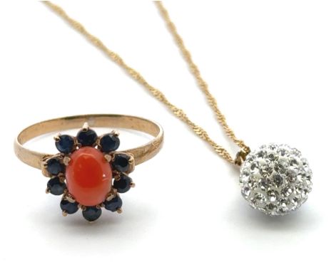 A coral and sapphire cluster ring, size N. Stamped 18k 1.48g. Chip to stone. And a white stone set ball pendant necklace stam