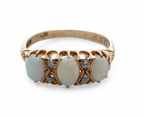 An opal and diamond ring, size N. A yellow metal scroll mount, marks rubbed. Inscribed with initial MKC(?) and dated 1909. 3.