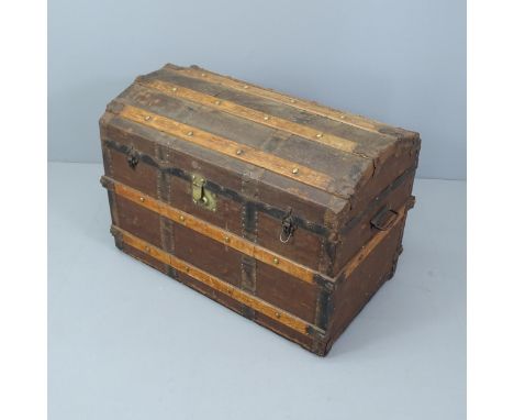 A Victorian dome top trunk, with tray fitted interior and various travel labels to the interior including Cunard. 85x59x50cm.