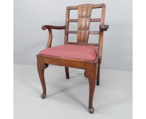 Wylie and Lochhead, a 1930s Art Deco armchair in walnut with shaped back and leather seat, with maker's label. 