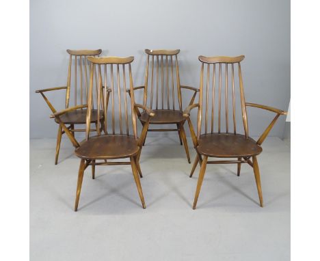 Four Ercol open arm chairs. 