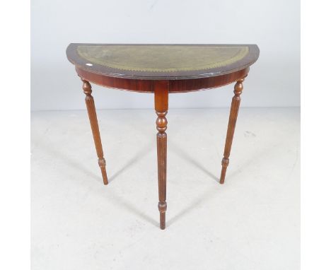 A reproduction mahogany demi-lune console table with inset tooled and embossed leather panel. 78x75x39cm. 