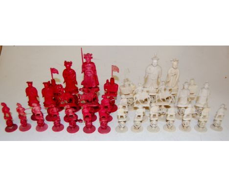 A complete early 20th century carved ivory Canton chess set, the pieces raised on puzzle balls (a/f)