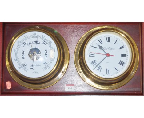 A wall mounted clock and barometer