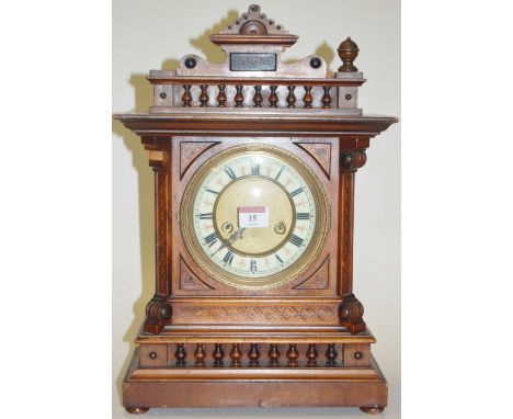 An early 20th century continental walnut cased mantel clock having enamel dial with Roman numerals