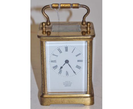 An early 20th century brass cased carriage clock having a white enamel dial with Roman numerals, signed Connel, 83 Cheapside,