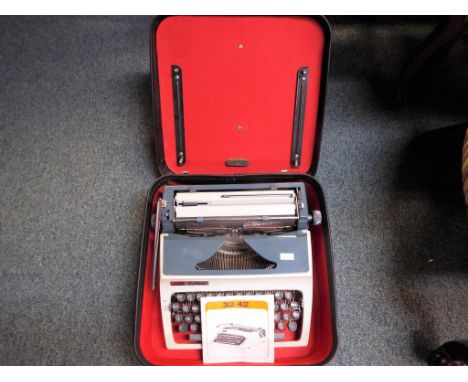 A vintage Daro Erika typewriter in case Est £20 - £40