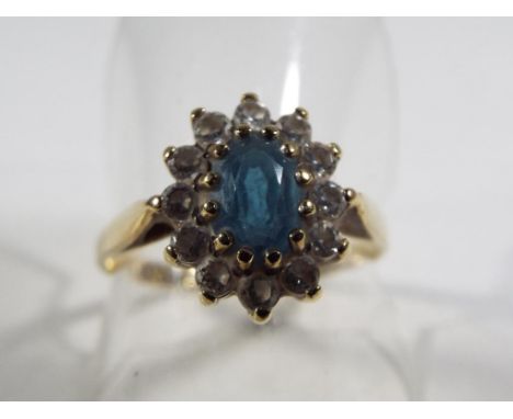 A lady's hallmarked 9 carat gold Topaz and CZ cluster ring, size Q, approximate weight 2.08 grams. Estimate £30 - £40