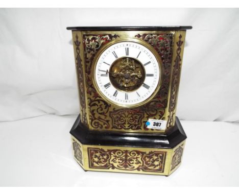 A French ebonised, tortoiseshell and boulle work mantel clock with open dial centre displaying the working clock movement, th