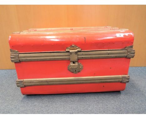 A good quality red and gold metal travel trunk. Estimate £20 - £30