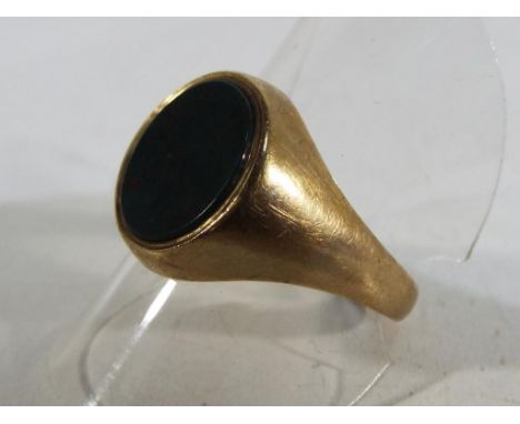 A hallmarked 9 carat yellow gold signet ring stone set, size T and a half, total weight 5.1 grams. Estimate £30 - £50