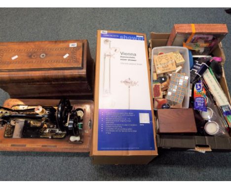 A good lot to include a vintage Frister and Rossman sewing machine in case and a box containing a quantity of lady's hats, cr