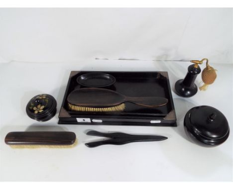 A vintage ebony dressing table set to include brushes, perfume atomiser, lidded trinket box with the tray having George V hal