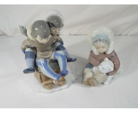 Lladro - two figures comprising an Eskimo Boy with pet Polar Bear # 1195 with blue stamp to base, 12 cm (h) and two children 