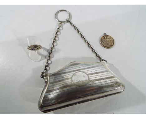 A white metal evening purse with brown fabric fitted interior and chain handle with suspension ring, a silver and 9 ct gold r