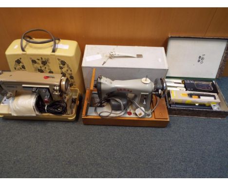 Two vintage Jones sewing machines in cases, a quantity of multi-function lamps, bike lights and a portable cassette player.