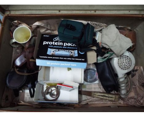 A vintage suitcase containing a mixed lot to include vintage Matchbox covers, Morphy Richards vintage hairdryer, a Ridgeway c
