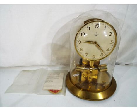 An early battery driven Junghans Ato 1000-day brass mantel clock, silvered dial with applied Arabic numerals, with original g