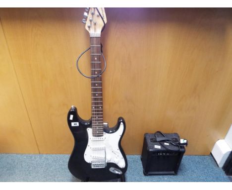 A good lot to include a Burswood electric guitar, a guitar amplifier and guitar stand (3) Est £20 - £40