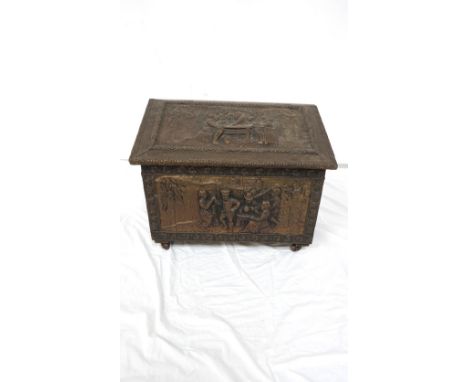 BRASS COAL BIN 
with embossed tavern scenes, the interior with a lift out liner, on wheels, 45.5cm high x 60cm wide x 32cm de