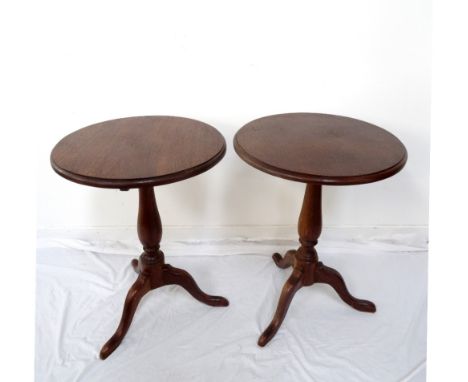 TWO MAHOGANY TRIPOD TABLES
each with a circular moulded top on a turned column with three outswept supports, 74cm high 
