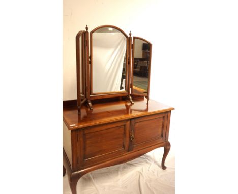 MAHOGANY SIDE CABINET
with a raised back and moulded top above a pair of panelled cupboard doors, standing on cabriole suppor