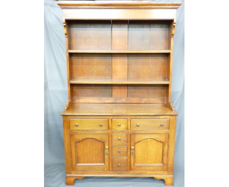 A LATE 19TH CENTURY OAK DRESSER of neat proportions, having a two-shelf rack over a T arrangement of three frieze and three b