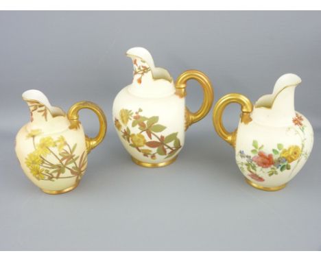 ROYAL WORCESTER - three non-matching graduated blush flat-back jugs, all with scuttle shaped spouts and with lined gilt handl