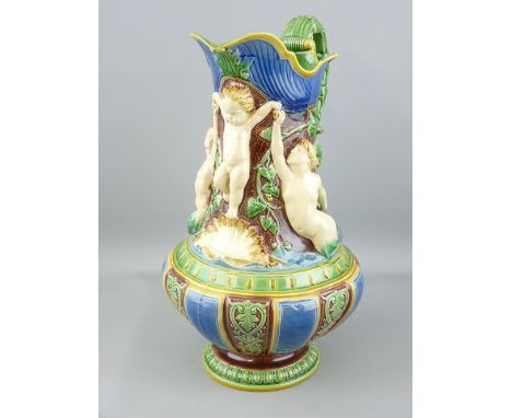 A 19TH CENTURY MINTON MAJOLICA PITCHER/JUG showing a cherubic figure held aloft by a merman and mermaid, impressed factory ma
