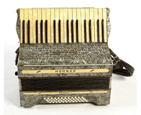 A Hohner Tango 48 bass piano accordion, in fiber case.