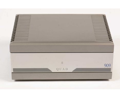 A Quad 909 stereo power amplifier, together with instruction manual and original box.