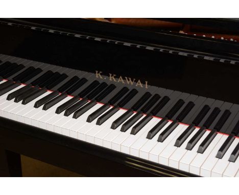 A K. Kawai black lacquered baby grand piano, on square tapering supports, with integral music stand; together with a music st