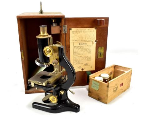 W.R. PRIOR &amp; CO; a black lacquered microscope in mahogany case with assorted lenses and slides.