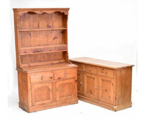 A 19th century pine dresser with boarded plate rack, shelf and four short drawers on base of two short drawers over twin cupb