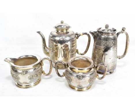 A circa 1900 Chinese Export silver three piece coffee set featuring chrysanthemum against chevron ground within foliate borde