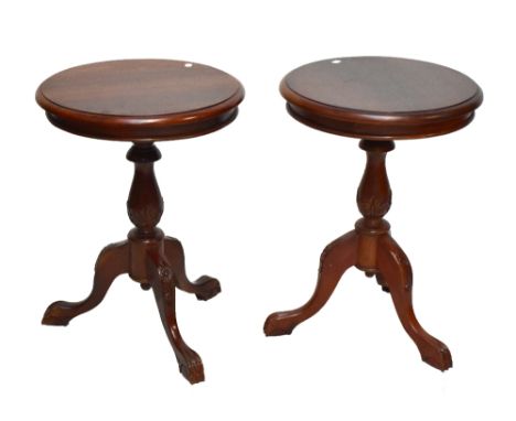 A pair of reproduction mahogany circular topped tripod tables, height 68cm (2).